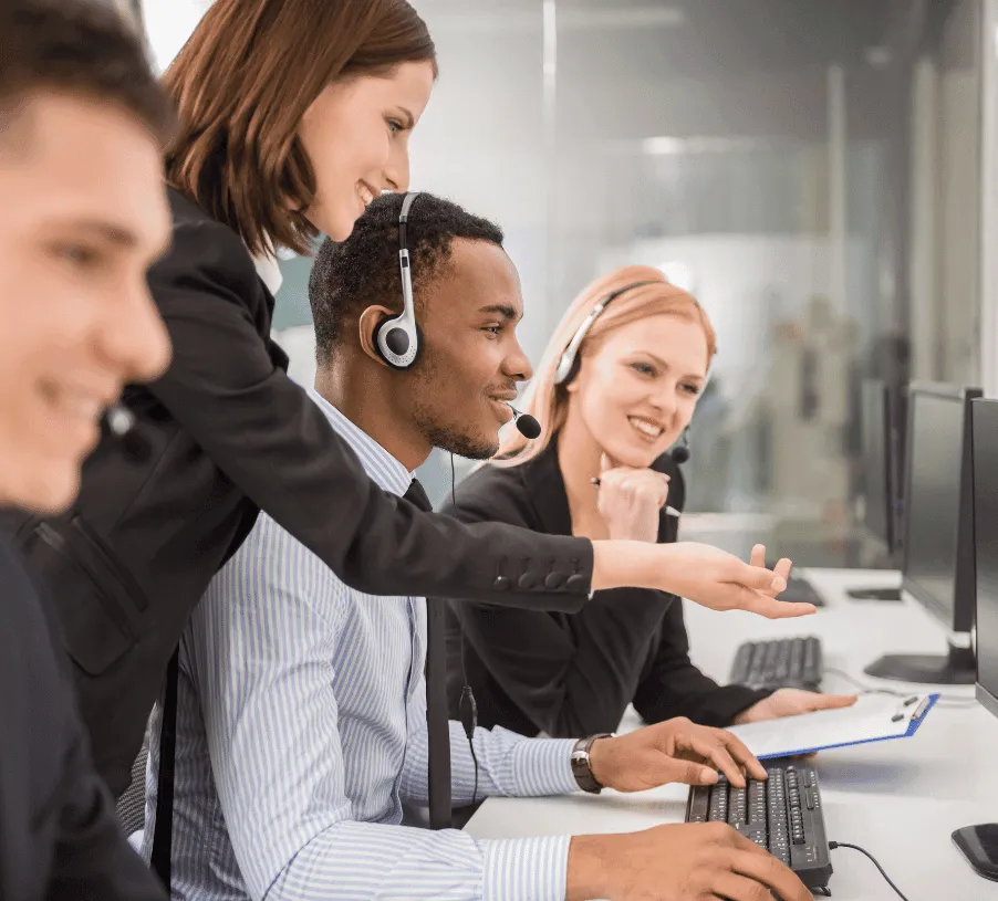 Call centre staff taking customer calls at computer stations