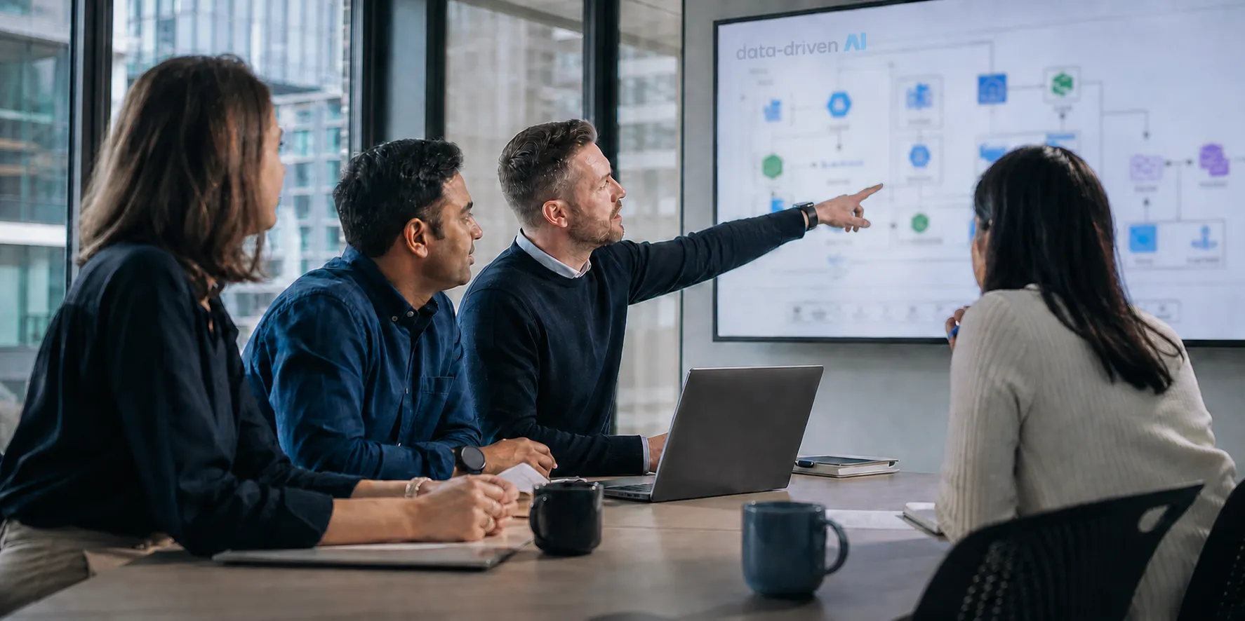 Illustration of four people reviewing a data-platform architecture on a screen in a workshop.